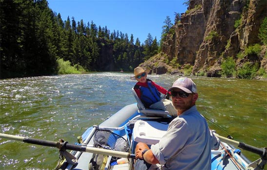 Blackfoot River Fly Fishing Guide and Young Fisherman in Raft on the Blackfoot River